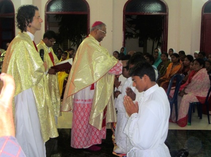 Bishop Gali Bali lays hands on each of those to be ordained.